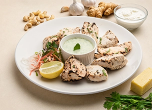 Indian chicken tikka kebabs roasted in tandoor with chutney at Best Indian restaurant in Singapore. 